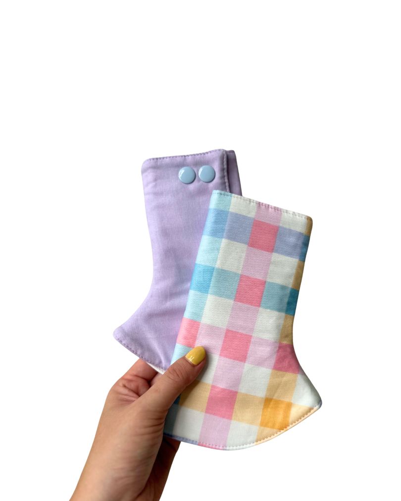Baby in a baby carrier with a colorful suckapds for drool